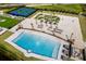 Aerial view of a beautiful resort-style pool, miniature golf course, and tennis courts at 130 Riviera Dunes Way # 1201, Palmetto, FL 34221