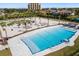 Aerial view of a beautiful resort-style pool surrounded by lounge chairs and a miniature golf course at 130 Riviera Dunes Way # 1201, Palmetto, FL 34221