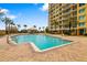 Exterior view of the pool with tanning chairs at 130 Riviera Dunes Way # 1201, Palmetto, FL 34221