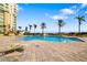 Inviting outdoor pool with blue sky and lounge area at 130 Riviera Dunes Way # 1201, Palmetto, FL 34221
