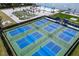 Aerial view of tennis courts, pool, miniature golf, and more resort-style amenities at 130 Riviera Dunes Way # 1201, Palmetto, FL 34221