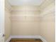 Walk-in closet featuring a door, wood floors and wire shelving at 130 Riviera Dunes Way # 1201, Palmetto, FL 34221