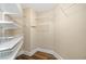 Walk-in closet featuring wire shelving, and wood floors at 130 Riviera Dunes Way # 1201, Palmetto, FL 34221