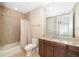 Bright bathroom featuring a bathtub with shower, vanity with marble countertop, toilet, and tile flooring at 130 Riviera Dunes Way # 902, Palmetto, FL 34221