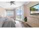Cozy bedroom with water views, a flat-screen TV, and elegant wood furniture at 130 Riviera Dunes Way # 902, Palmetto, FL 34221
