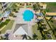 Aerial view of a stunning community pool with sun loungers and lush landscaping at a resort at 130 Riviera Dunes Way # 902, Palmetto, FL 34221