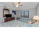 Cozy bedroom with a queen bed, ceiling fan and a window with blinds at 1300 Gulf Blvd # 202, Indian Rocks Beach, FL 33785