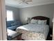 Comfortable bedroom featuring a queen bed, ceiling fan and a window with blinds at 1300 Gulf Blvd # 202, Indian Rocks Beach, FL 33785