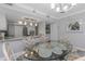 Cozy dining area featuring a glass table, decorative chairs, and seamless access to the kitchen at 1300 Gulf Blvd # 202, Indian Rocks Beach, FL 33785