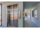 Elevator in hallway of building, adjacent to the fire extinguisher, and windows at the end at 1300 Gulf Blvd # 202, Indian Rocks Beach, FL 33785