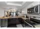 Modern kitchen with stainless steel appliances, granite countertops and ample cabinet space at 1300 Gulf Blvd # 202, Indian Rocks Beach, FL 33785