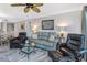 Inviting living room with comfortable seating, stylish decor, and modern ceiling fan at 1300 Gulf Blvd # 202, Indian Rocks Beach, FL 33785