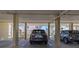 Car parked in a concrete parking garage with view of nearby buildings in the background at 1300 Gulf Blvd # 202, Indian Rocks Beach, FL 33785