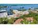 An aerial view of the building by the water, nestled in a lush, tropical landscape at 14021 Bellagio Way # 309, Osprey, FL 34229