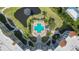 Aerial view of community pool, pond, manicured landscaping, and building architecture at 14021 Bellagio Way # 309, Osprey, FL 34229