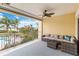 Relaxing covered balcony with outdoor seating and a view of lush greenery and a pool at 14021 Bellagio Way # 309, Osprey, FL 34229