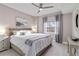 Bedroom features neutral tones, a woven headboard, and a ceiling fan at 14021 Bellagio Way # 309, Osprey, FL 34229
