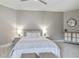 Bedroom with a large bed, two side tables with lamps, and a cabinet with a mirror at 14021 Bellagio Way # 309, Osprey, FL 34229