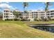 This is a beautiful condo building with many units overlooking a lush green lawn and pond at 14021 Bellagio Way # 309, Osprey, FL 34229