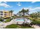 An expansive pool with ample seating surrounded by meticulously maintained landscaping with water views at 14021 Bellagio Way # 309, Osprey, FL 34229