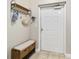 Cozy entrance area with a coat rack, bench, and a white door at 14021 Bellagio Way # 309, Osprey, FL 34229