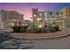 Stunning building exterior featuring a landscaped roundabout, tile roof, and neutral color palette at 14021 Bellagio Way # 309, Osprey, FL 34229