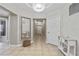 Open and airy hallway with tile floors, neutral walls, and stylish decor at 14021 Bellagio Way # 309, Osprey, FL 34229