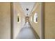 Bright hallway featuring neutral colors, arched windows, and decorative lighting at 14021 Bellagio Way # 309, Osprey, FL 34229