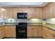 Bright kitchen featuring stainless steel appliances, wooden cabinetry, and granite countertops at 14021 Bellagio Way # 309, Osprey, FL 34229