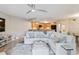 Cozy living room with a large sectional sofa, ceiling fan, and open access to the kitchen at 14021 Bellagio Way # 309, Osprey, FL 34229