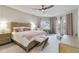 Beautiful main bedroom with a ceiling fan, desk, and a balcony overlooking a lake at 14021 Bellagio Way # 309, Osprey, FL 34229