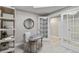 Office features natural light, desk with chair, shelving unit, and french door entrance at 14021 Bellagio Way # 309, Osprey, FL 34229