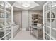 Office space with daybed, desk, shelving, and French doors offering a stylish workspace at 14021 Bellagio Way # 309, Osprey, FL 34229