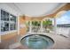 Outdoor spa features columns, tile accents, and views of the grounds at 14021 Bellagio Way # 309, Osprey, FL 34229