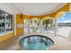 Exterior spa features columns, tile accents, and views of the grounds at 14021 Bellagio Way # 309, Osprey, FL 34229