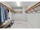 Spacious walk-in closet with built-in shelving, hanging racks, and a shoe bench at 14021 Bellagio Way # 309, Osprey, FL 34229