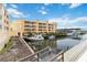 Beautifully landscaped yellow condo building with dock and water views at 14021 Bellagio Way # 309, Osprey, FL 34229