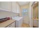 Laundry room features a washer and dryer with a window for natural light at 1407 Burgos Dr, Sarasota, FL 34238