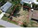 Aerial view of vacant lot showing property lines with nearby neighborhood and landscaping at 16733 Carmine Rd, Venice, FL 34293