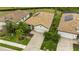 Aerial view of a home with a tile roof, brick driveway and manicured lawn at 17234 Blue Ridge Pl, Bradenton, FL 34211