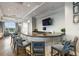 A modern bar area with a long curved countertop, comfortable seating, and a flat-screen TV at 17234 Blue Ridge Pl, Bradenton, FL 34211