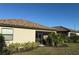 View of the home's exterior with landscaping and a screened in patio at 17234 Blue Ridge Pl, Bradenton, FL 34211