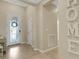 Bright foyer featuring a decorative front door, tile flooring, and neutral paint with 