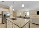 Open concept kitchen with stainless steel appliances and island, seamlessly connecting to the living spaces at 17234 Blue Ridge Pl, Bradenton, FL 34211