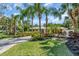 The home features lush landscaping, a verdant lawn, and a patterned brick driveway at 1766 Shoreland Dr, Sarasota, FL 34239