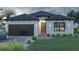 Beautiful single-story home featuring a two-car garage, manicured lawn, and charming curb appeal at 18 Jonesboro Ave, North Port, FL 34288