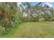 Spacious backyard featuring tropical landscaping and mature trees at 2 Antigua Cir # 4, Englewood, FL 34223