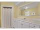 Bright bathroom with white cabinetry, a large mirror, and a clean, minimalist design at 2 Antigua Cir # 4, Englewood, FL 34223