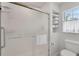 Bathroom featuring a glass enclosed shower and built-in shelving for towel storage at 2 Antigua Cir # 4, Englewood, FL 34223