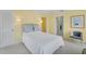 Serene bedroom features sunny yellow walls, soft blue accents, and a cozy chair by the doorway at 2 Antigua Cir # 4, Englewood, FL 34223